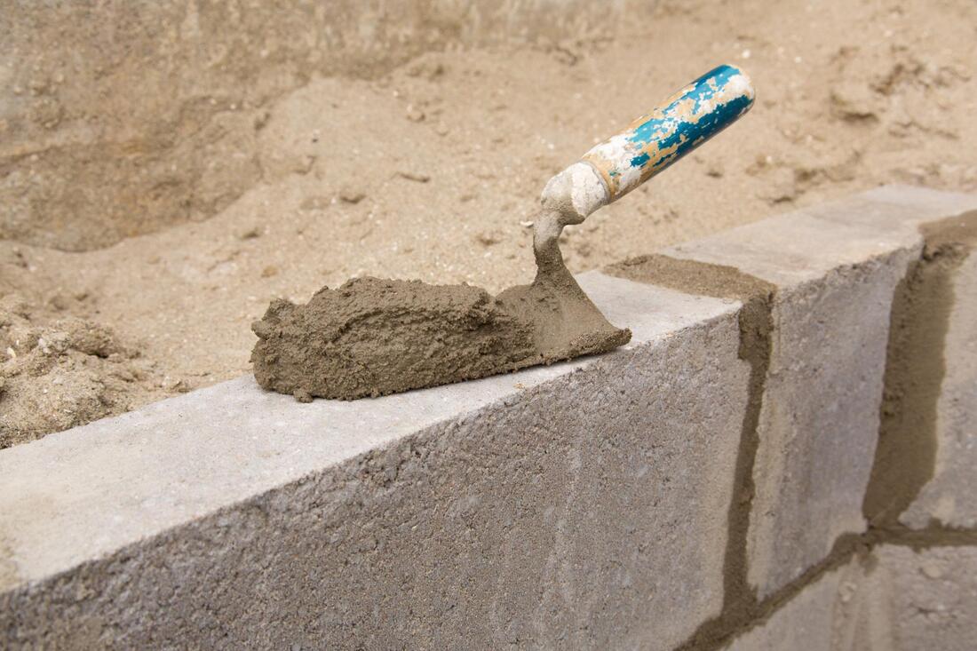 cement on a tool and concrete blocks
